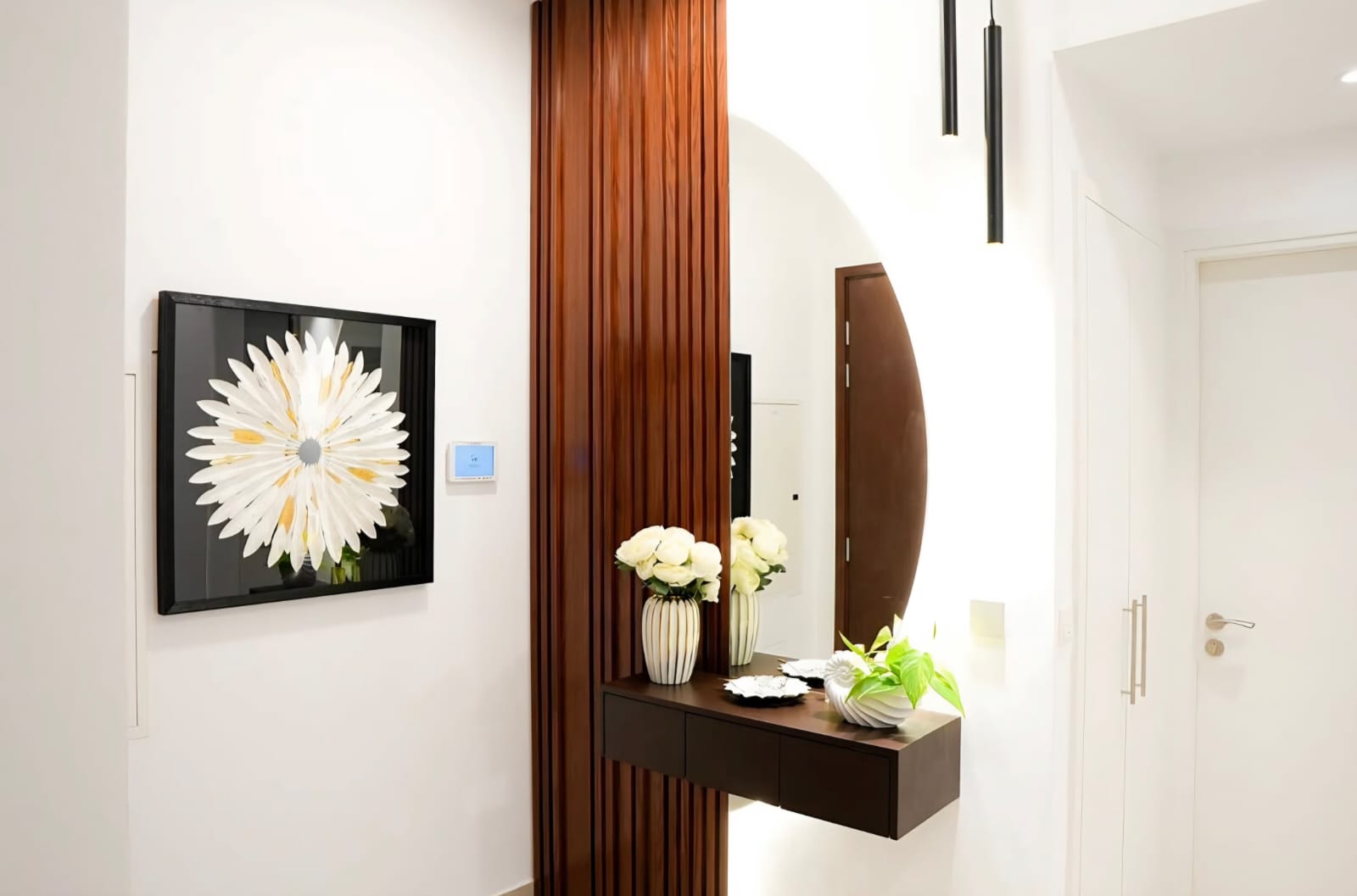 Town Square — Nshama, Dubai: entrance console with fluted wood fin and round mirror